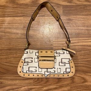 Guess cream with tan and gold accents shoulder bag. (5”x10.5”)